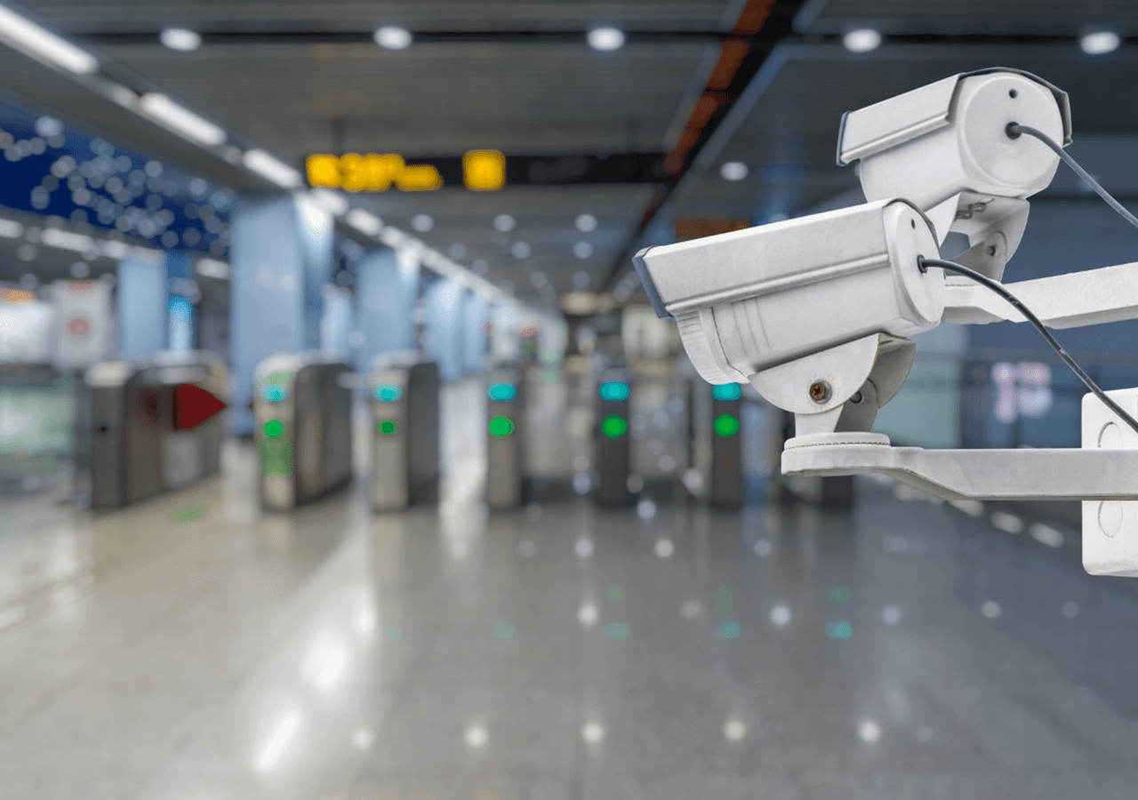 cctv security camera with abstract blurred subway station background - hallojulie