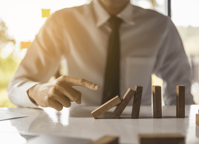 ©Adobstock Day Of Victory Businessman Pulling Or Placing Long Wooden Blocks In A Modern Office Indicates The Impact Or Management Risk Of The Business